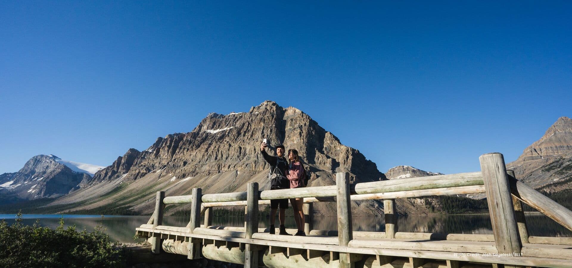 Two guests on a bridge in Banff National Park. Photo courtesy of BLLT.
