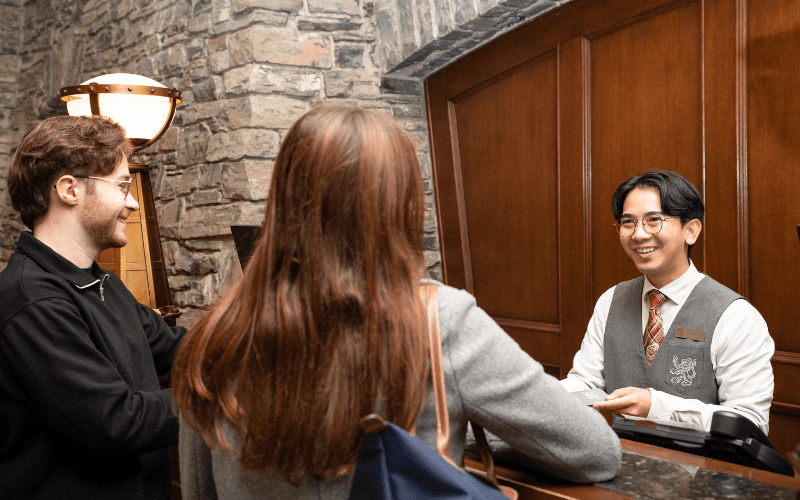 Hotel Front Desk Employee chatting with guests. Photo courtesy of BLLHA and Fairmont Hotels & Resorts